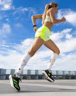 Woman running with compression socks.