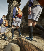 Men walking in field with compression socks.