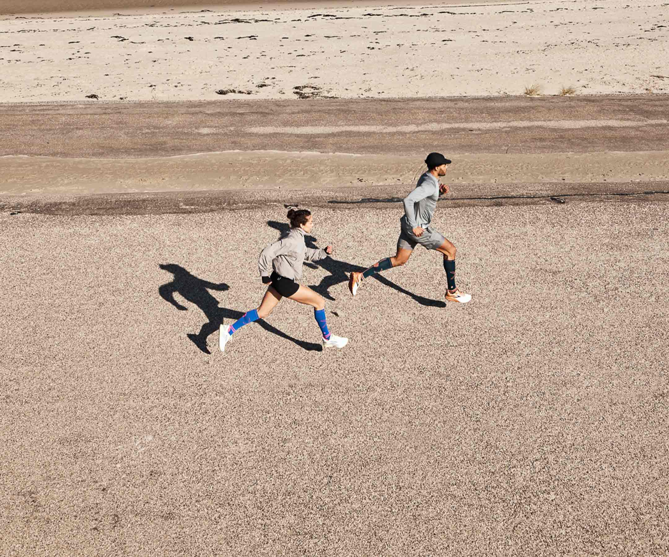 Sprinting man and women on the beach