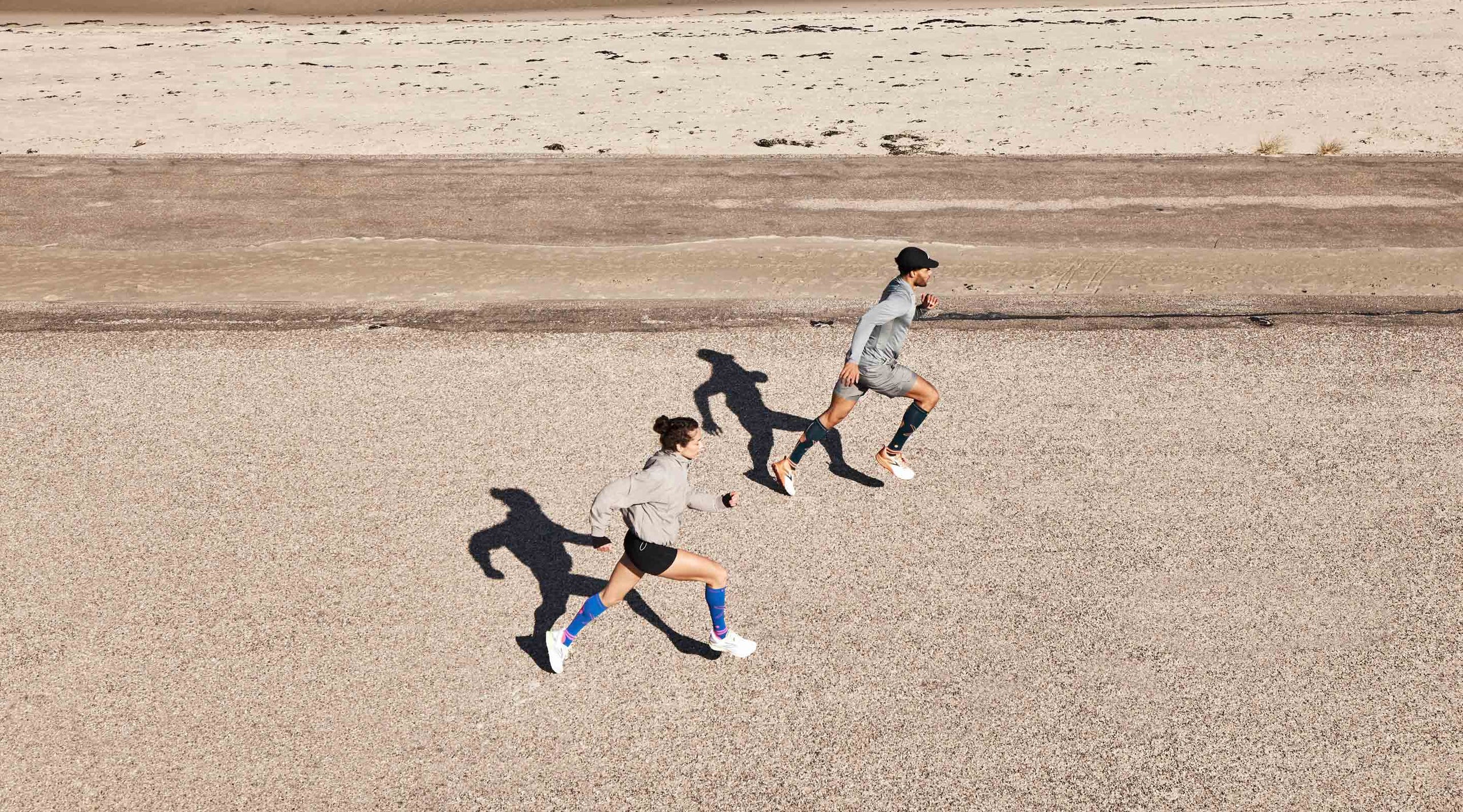 Men and woman running on the beach