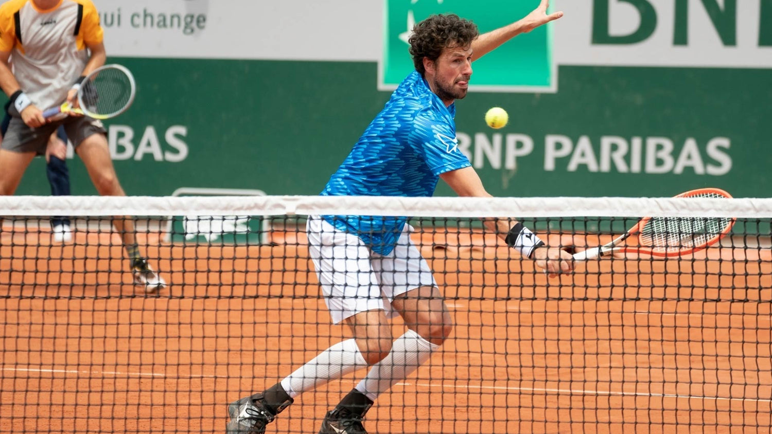Robin Haase on a tennis court with a blue shirt on.