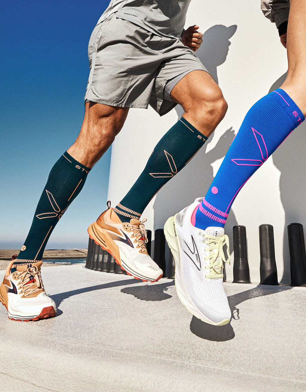 Two people running behind each other with white running shoes.
