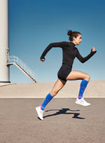 Girl running on a road with blue sky