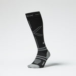 Front view of a black colored knee high compression sock with grey accents.