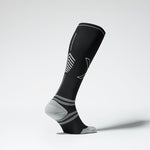 Side view of a black colored knee high compression sock with grey accents.