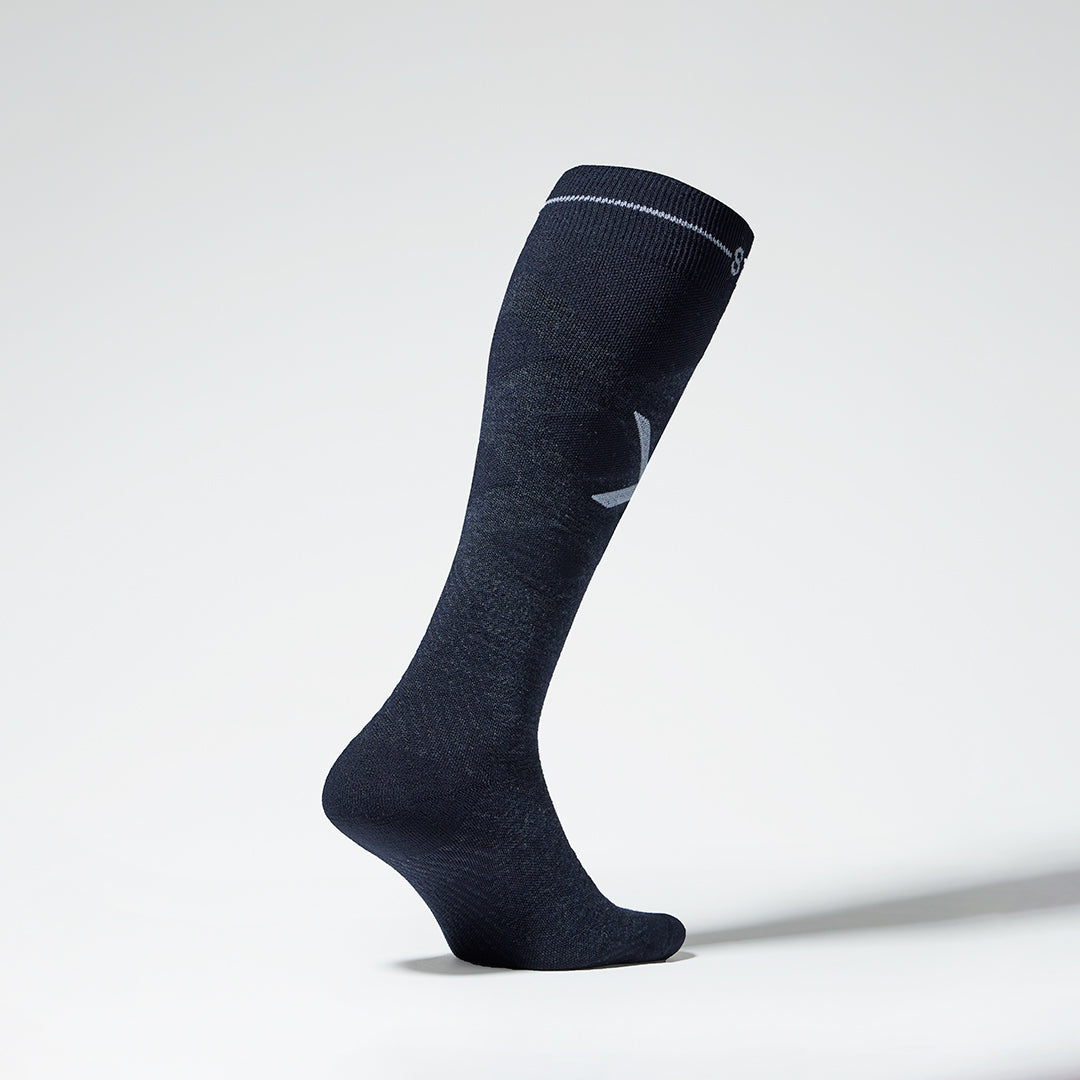 Side view of dark navy compression socks with white details.