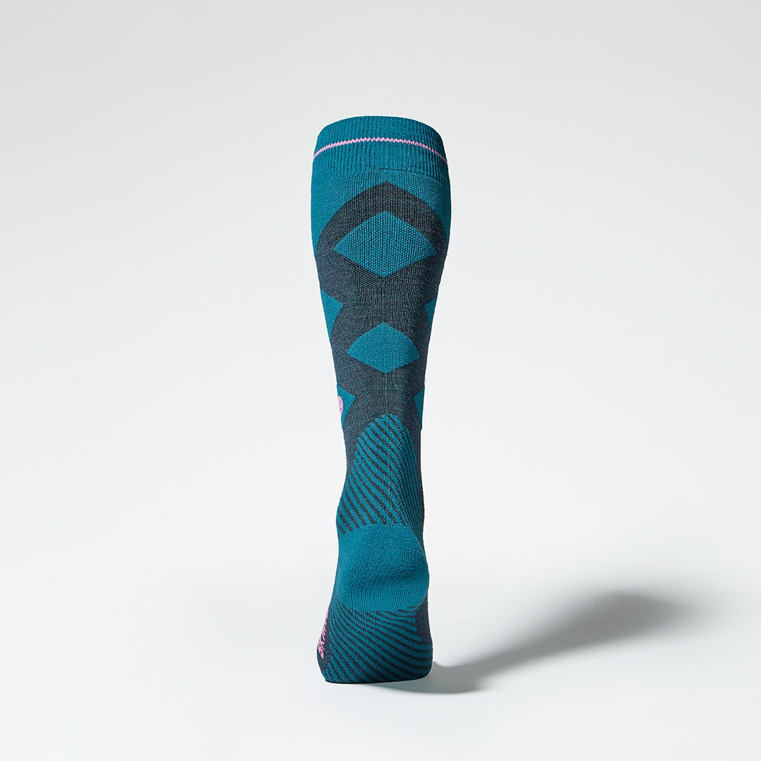 Back view of a teal compression skiing socks with pink details.