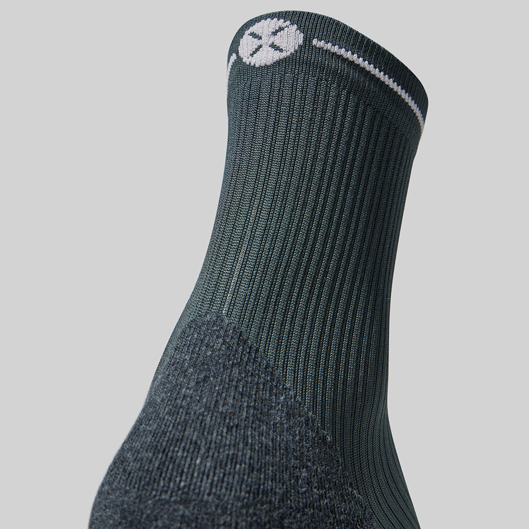 Grey compression sock with light grey logo.