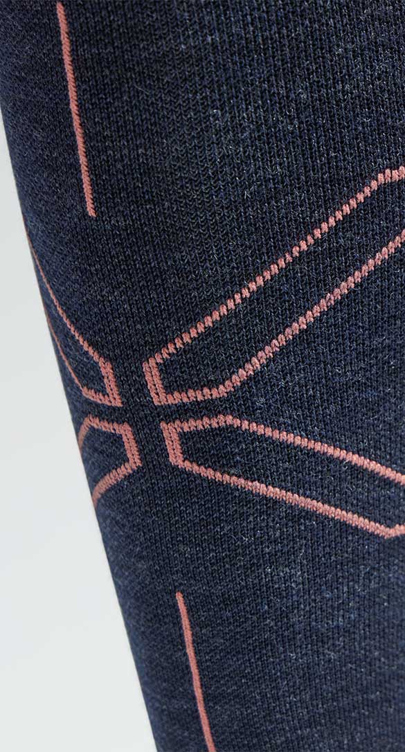 Close-up of a dark navy sock with a pink geometric design.