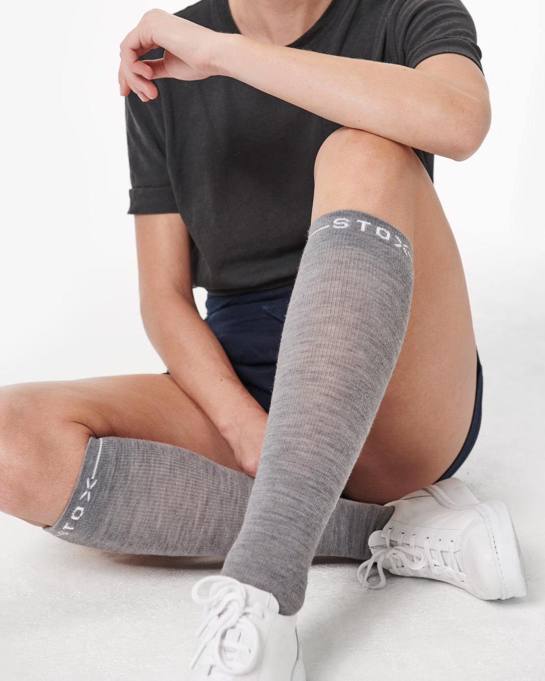 Sitting woman with compression socks.