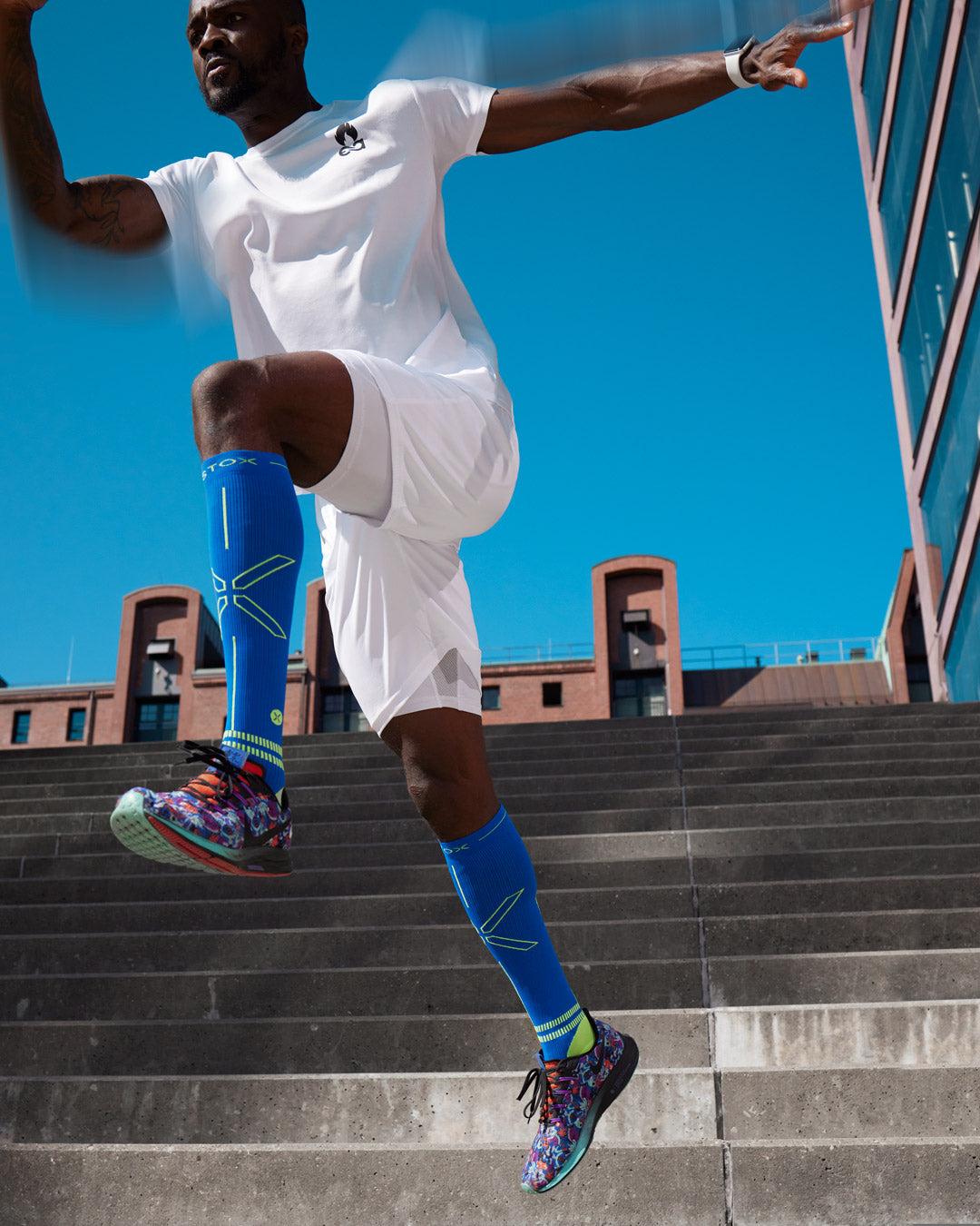 Man jumping from stairs with compression socks.