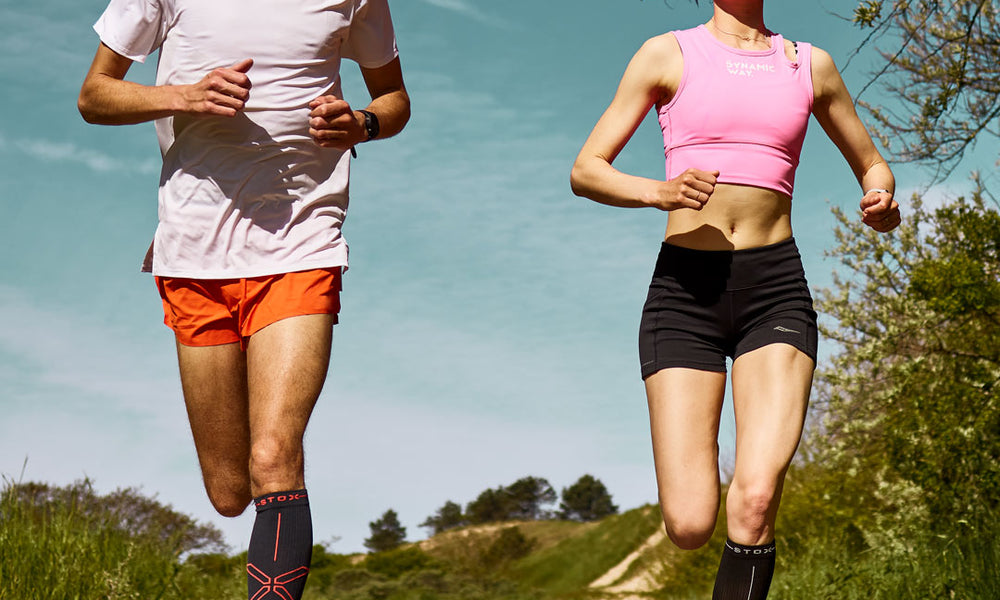 Duo running in the dunes with compression socks.