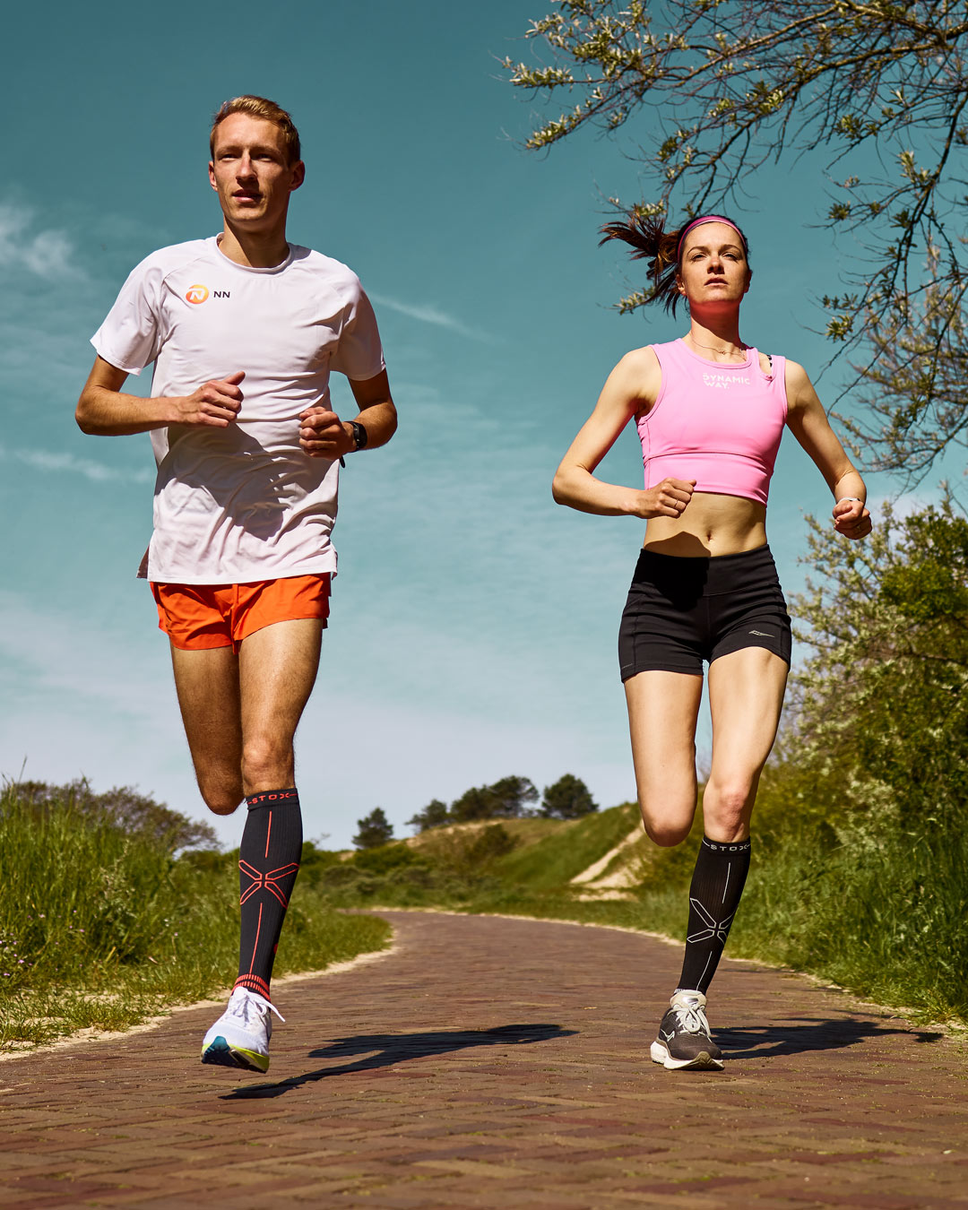 Duo running in the dunes with compression socks.