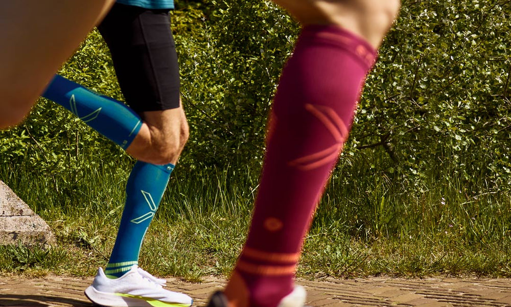 Duo running with compression socks.