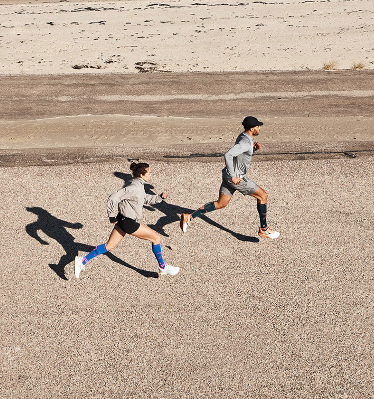 Sprinting man and women on the beach