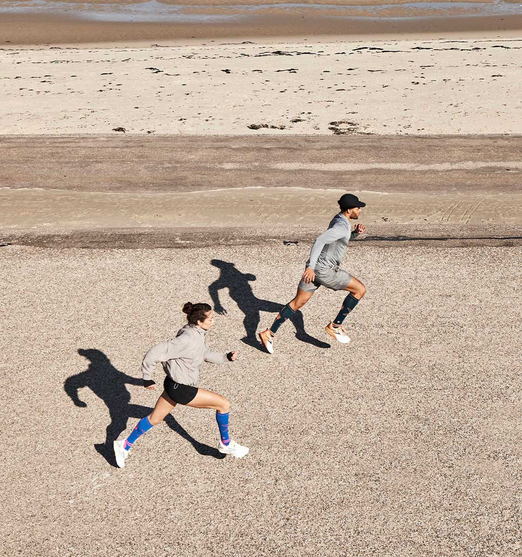 Men and woman running on the beach