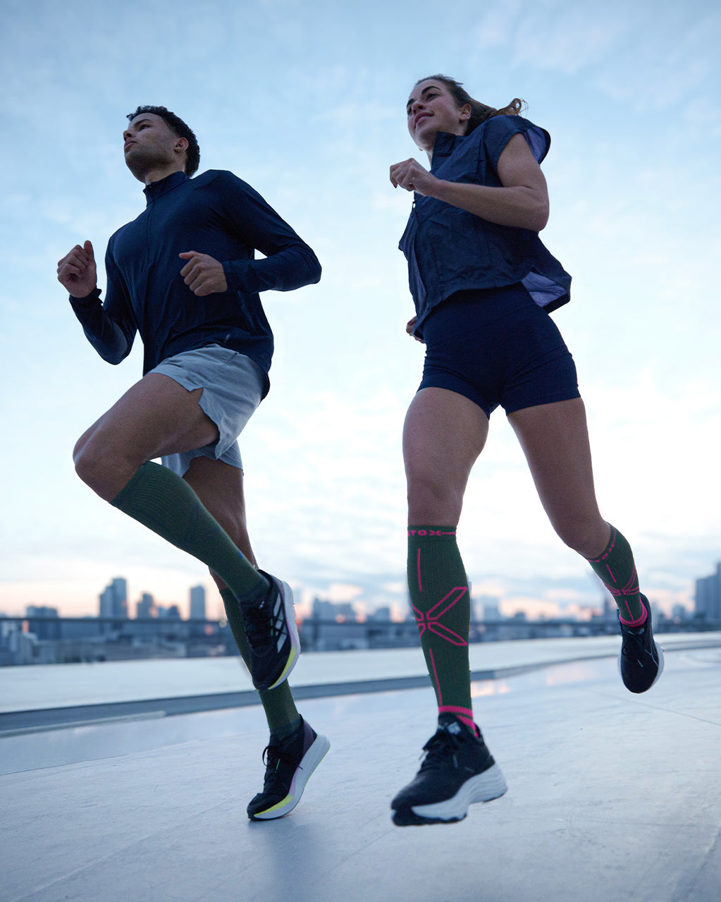 Duo running with sunset.