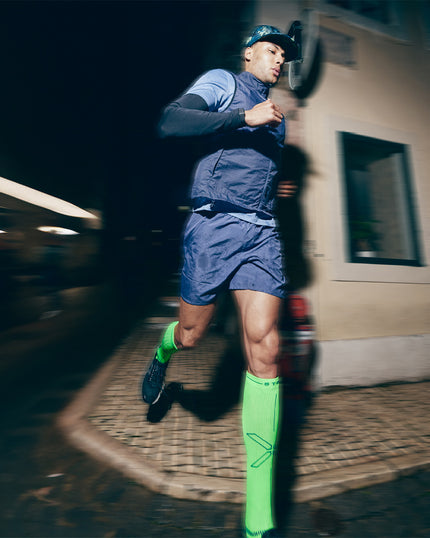 Man running in the dark on the street.