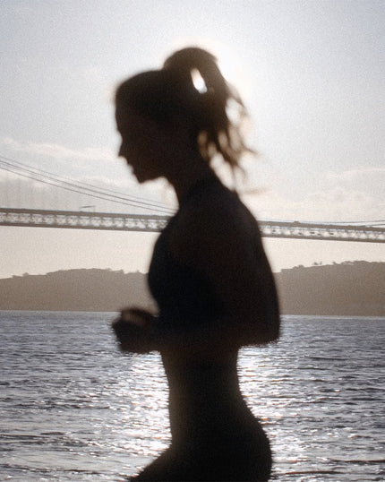 Girl warming up in front of water.