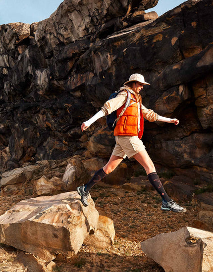 Jumping woman on rocks.