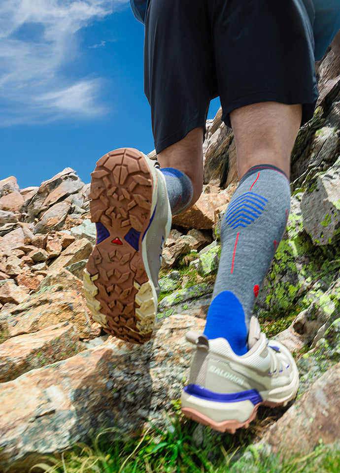 Two legs and feet climbing on rocks.