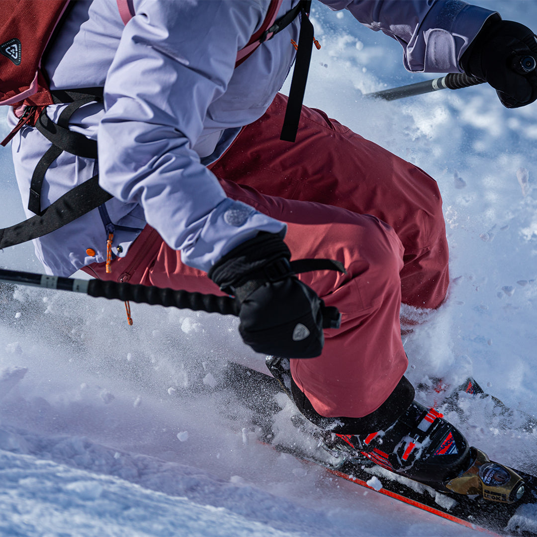 Person skiing in a colorful jacket and pants.