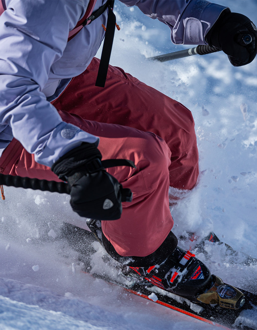 Person skiing in a colorful jacket and pants.