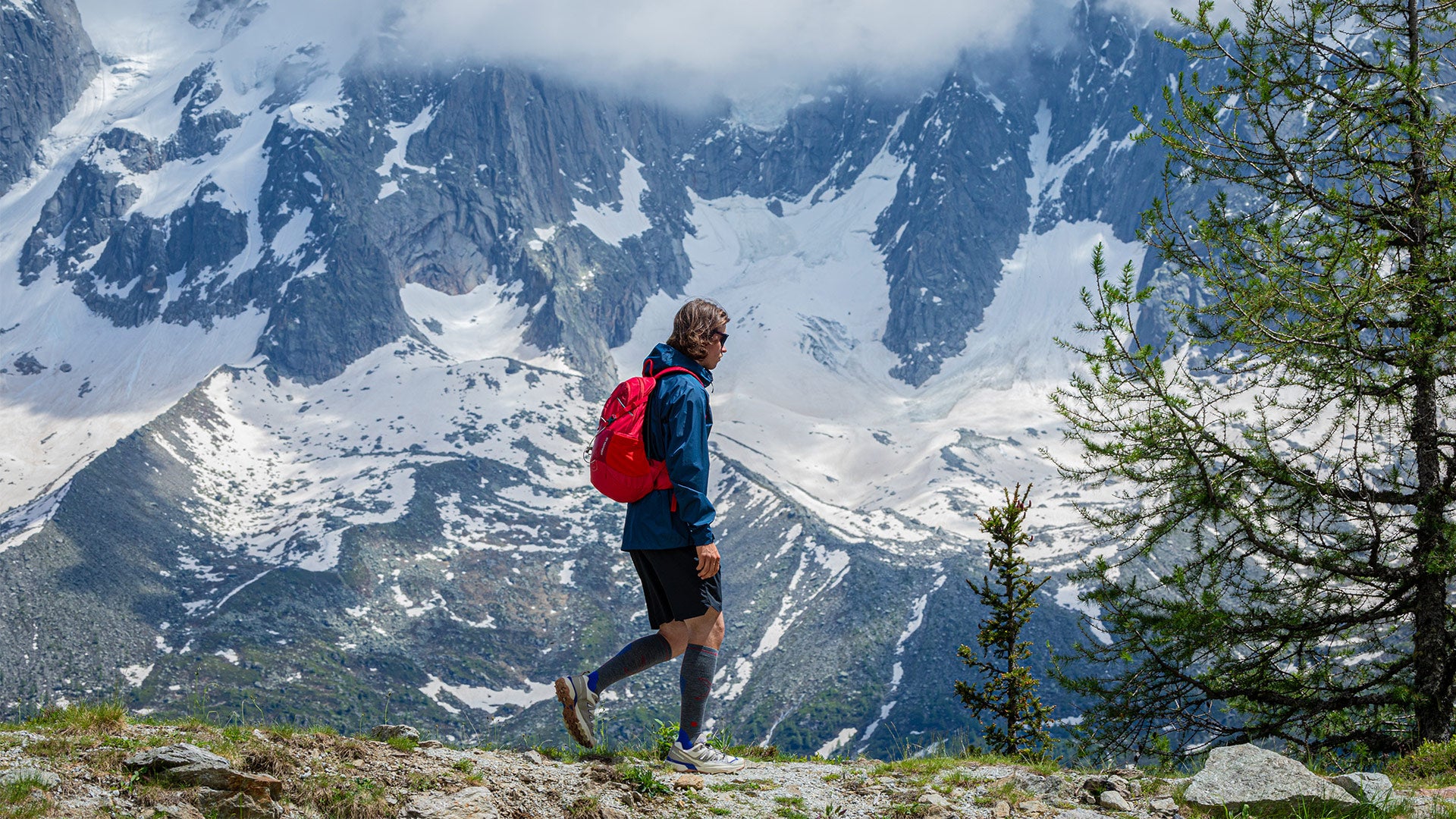 Man walking over rocks.