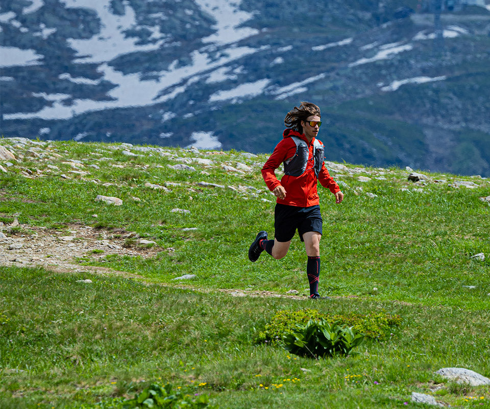 Men running on a field of grass.