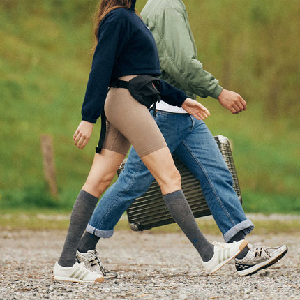 Couple walking with a suitcase.