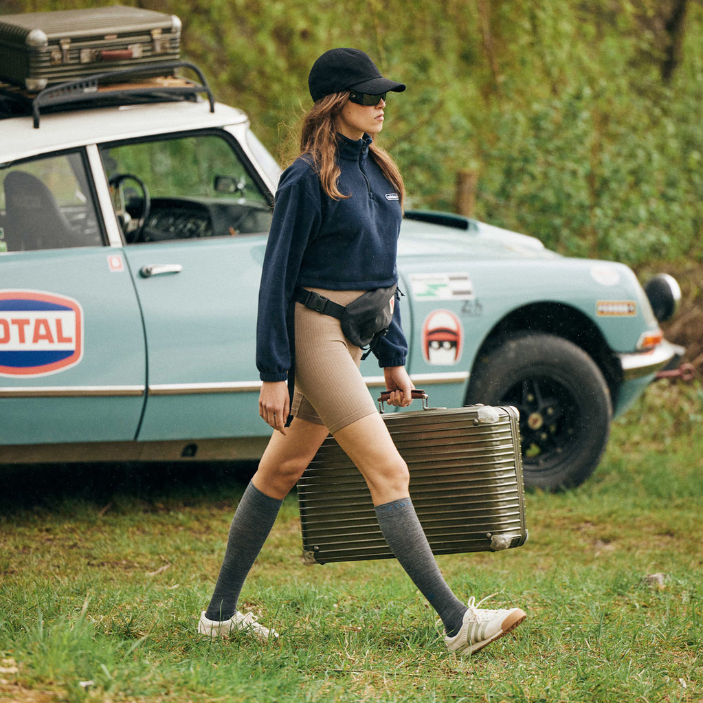 Women walking with a suitcase.