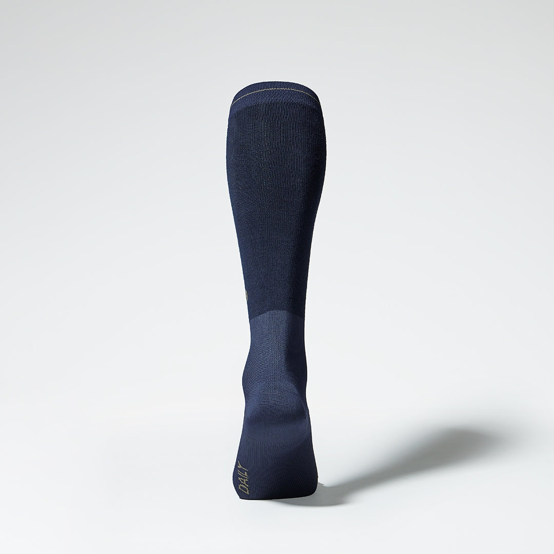 The back of a navy knee high compression sock.
