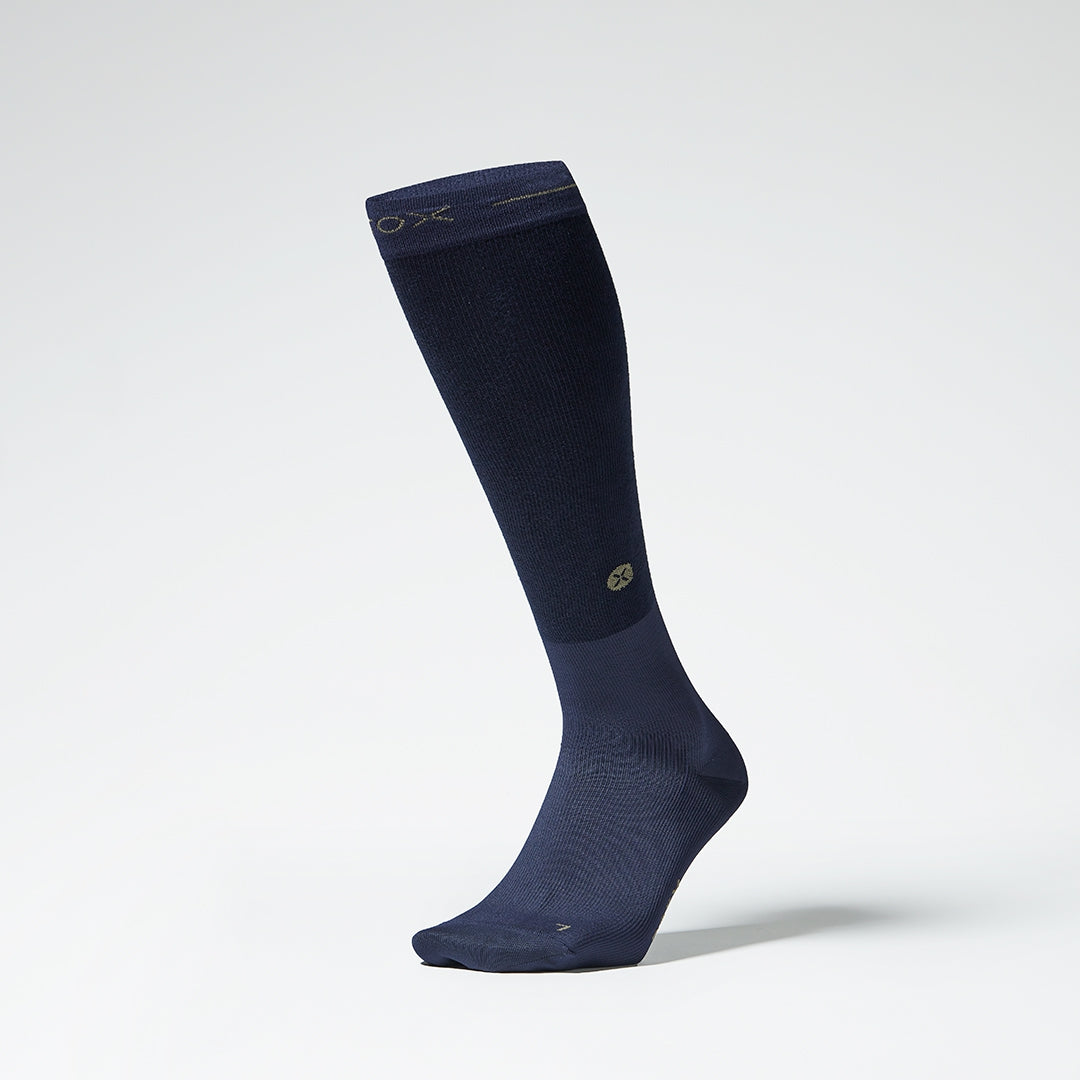 The front of a navy knee high compression sock.