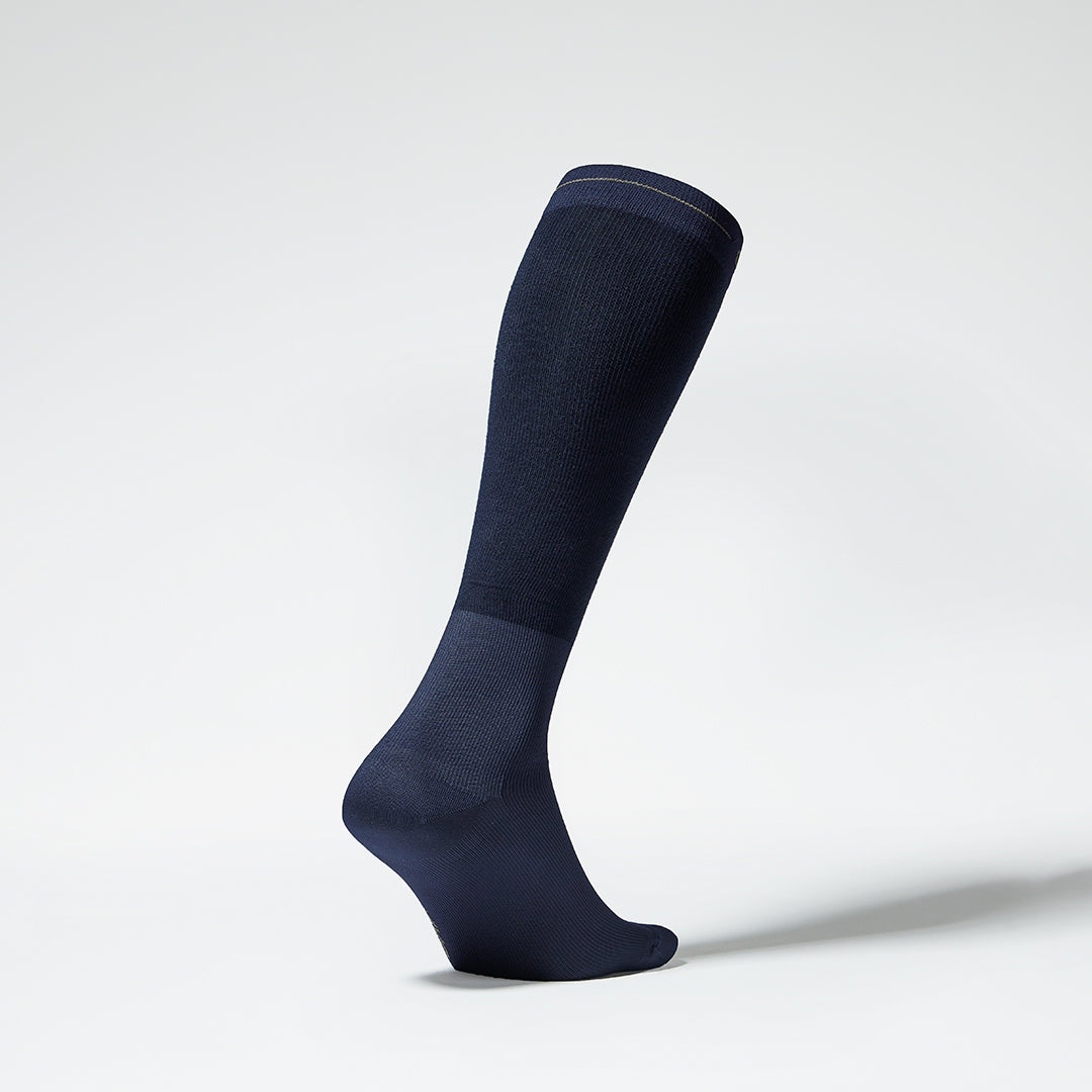 The side of a navy knee high compression sock.