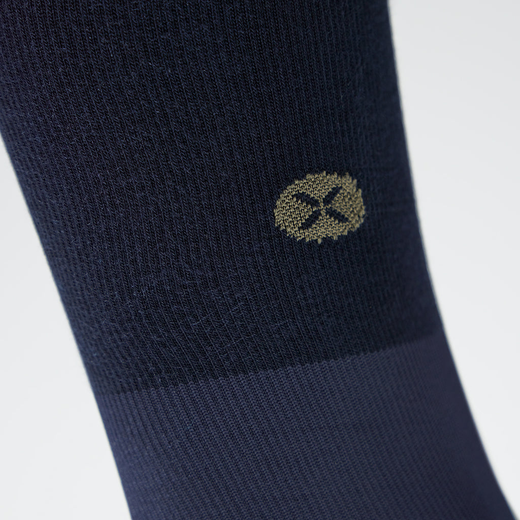 Close up of a navy compression sock with text.