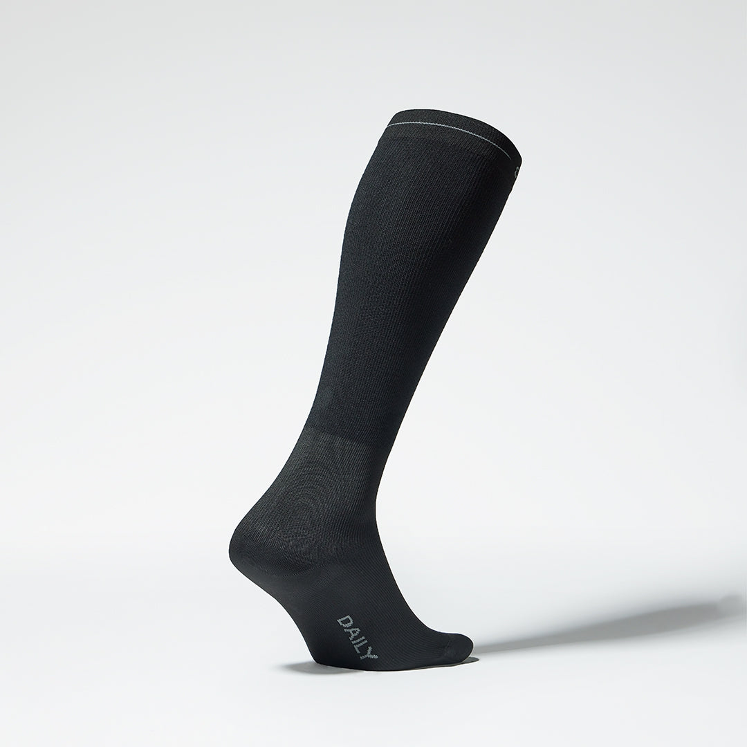 Side view of a black compression sock.