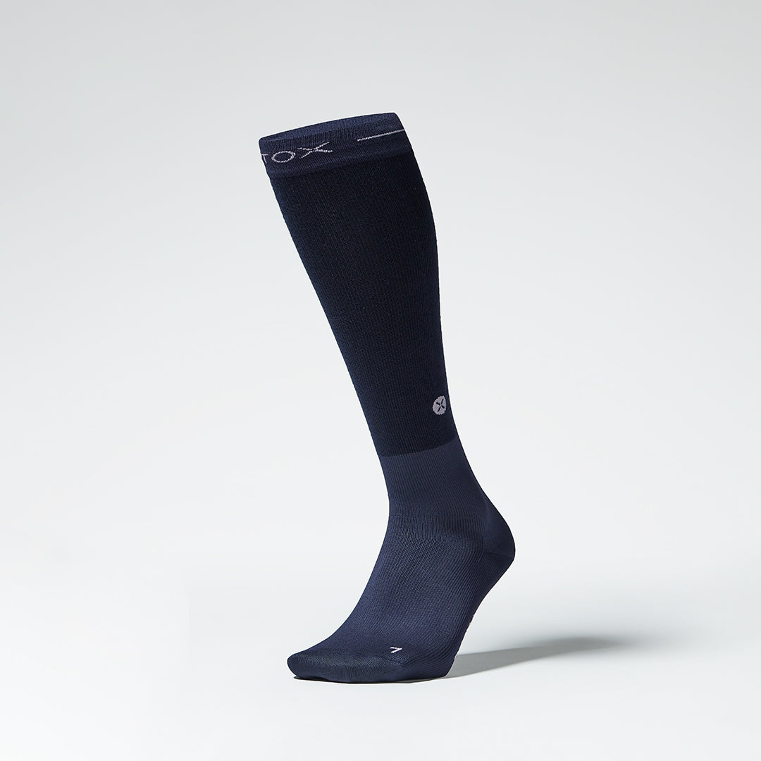 Front view of a navy compression sock.