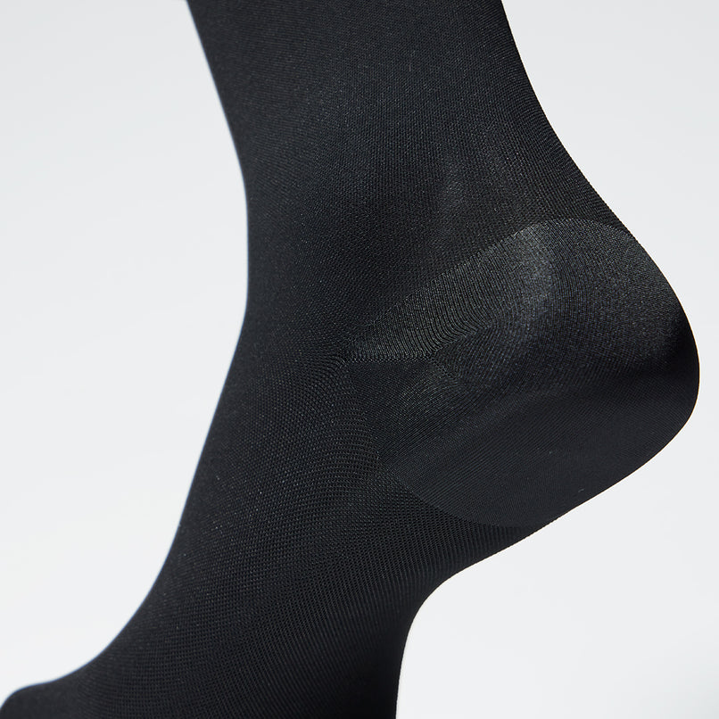 Detailed view of legs wearing compression tights for everyday use. 