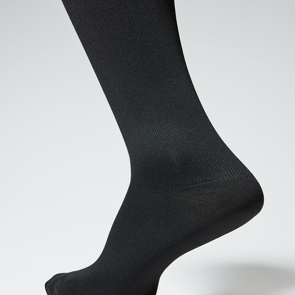 Detailed view of black unisex compression socks. 