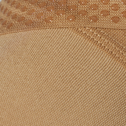 Detailed view of a medical thigh high stocking in a sand color. 