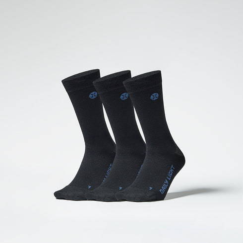 A three pack of black mid calf compression socks from the front.