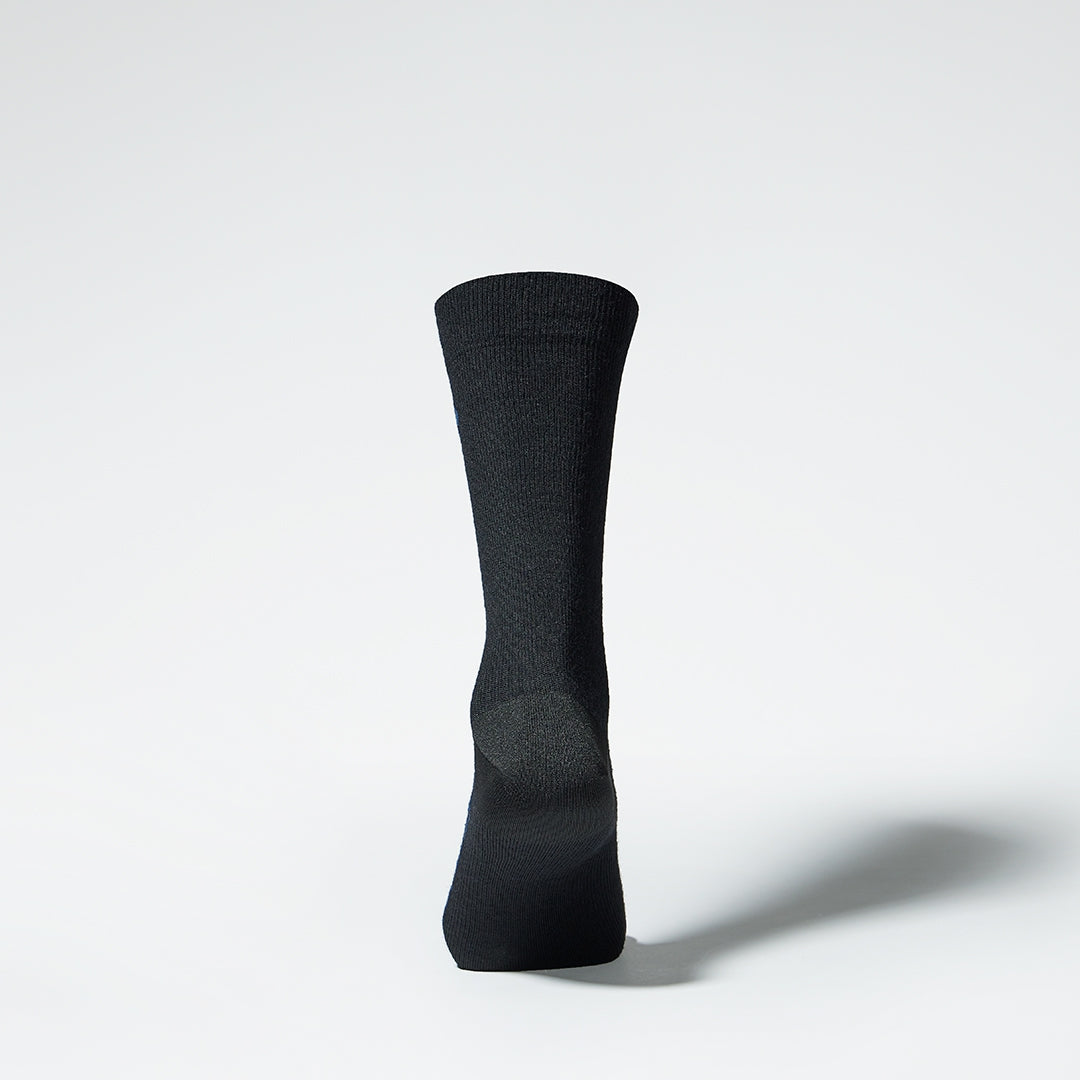 A black mid calf compression sock from the back.