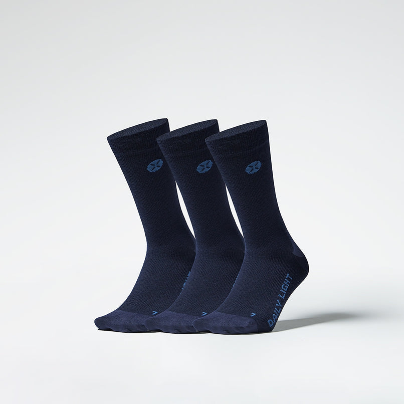 A three pack of dark blue mid calf compression socks from the front.