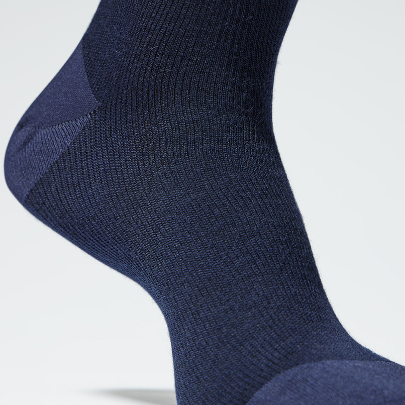 A close up of a blue mid calf compression sock. 