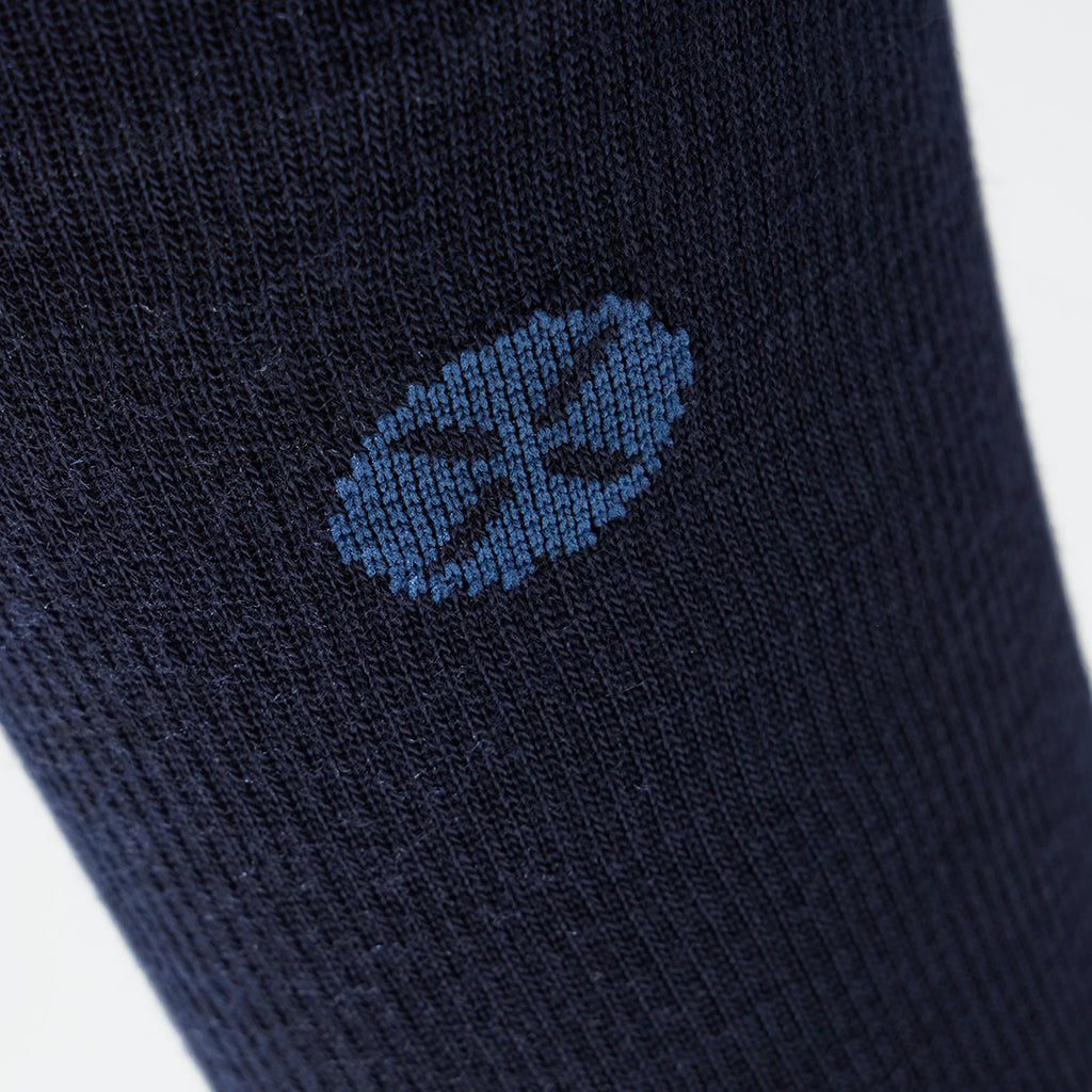 A close up of a blue mid calf compression sock with a blue logo.