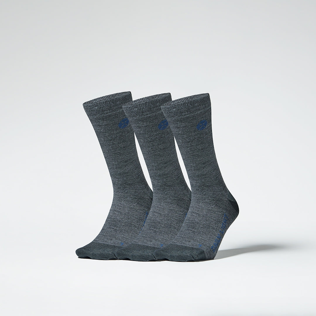 A three pack of grey mid calf compression socks from the front.