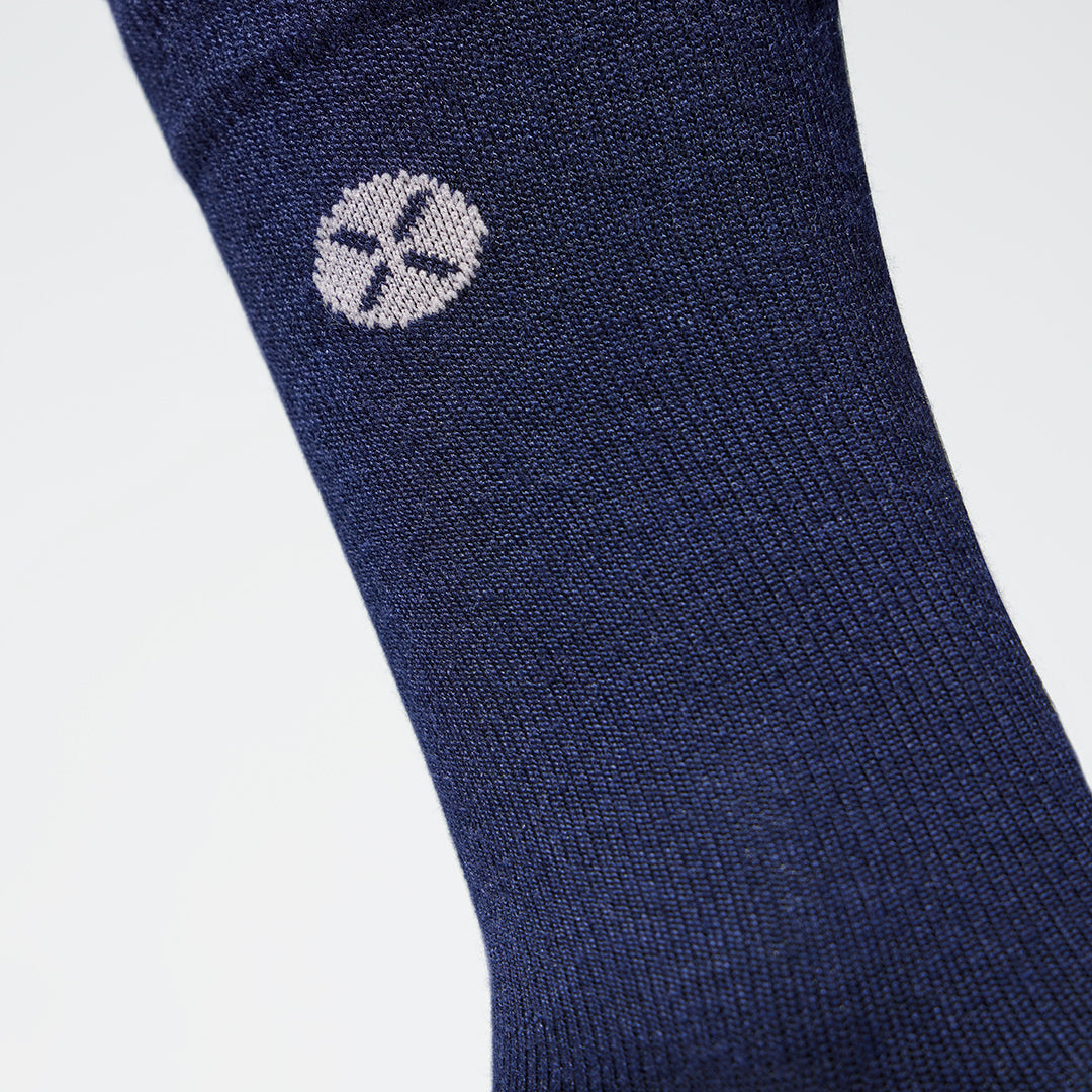 Detailed view of a blue compression sock with pink details.