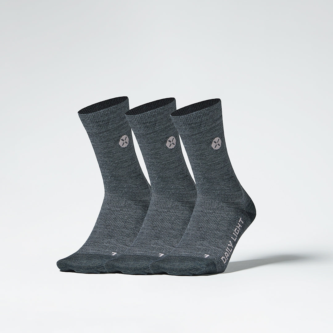 Front view of three mid-calf grey compression socks.