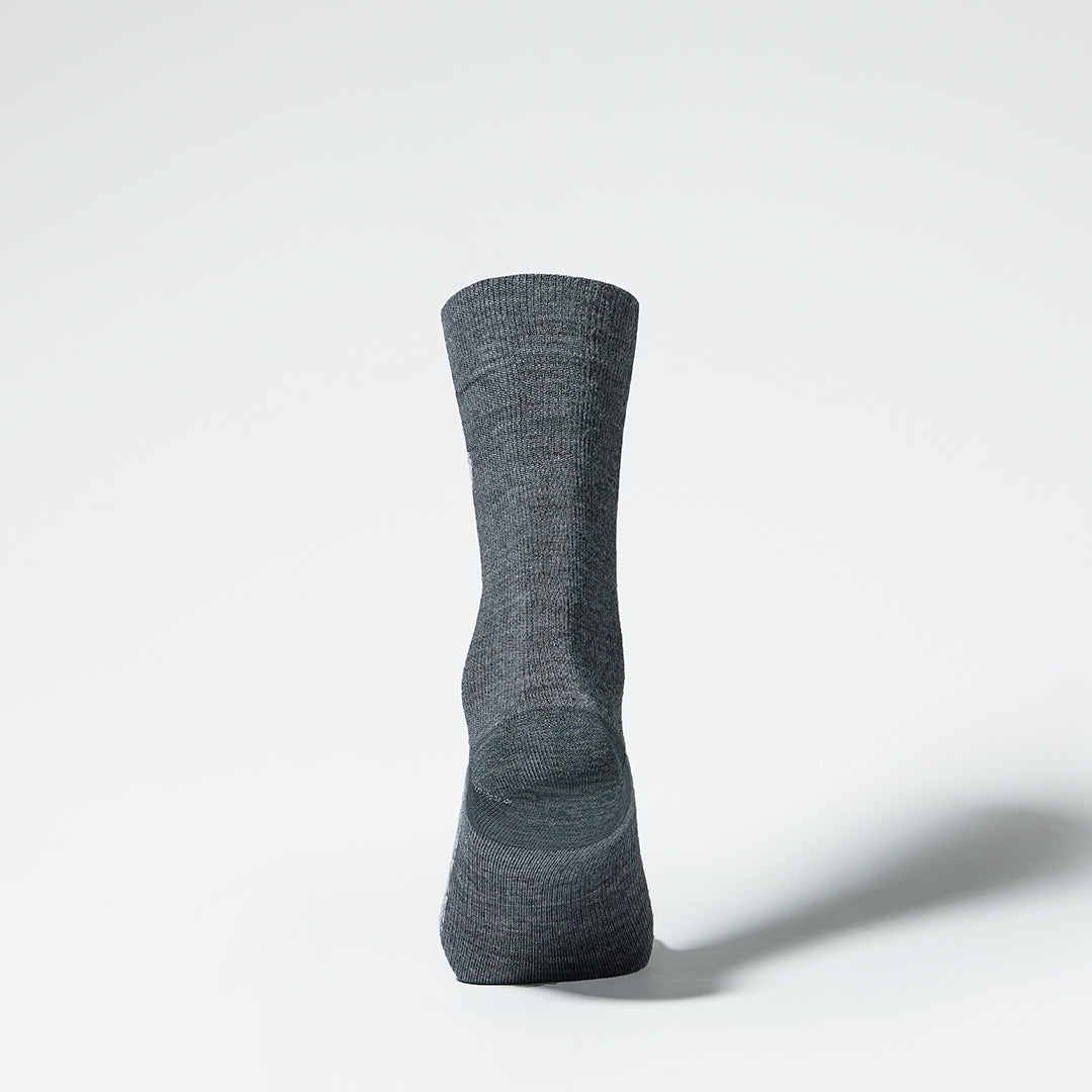 Back view of a mid-calf grey compression sock.
