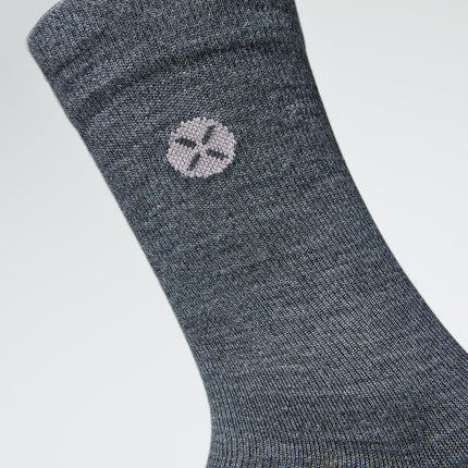 Detailed view of a short grey compression sock with pink details.